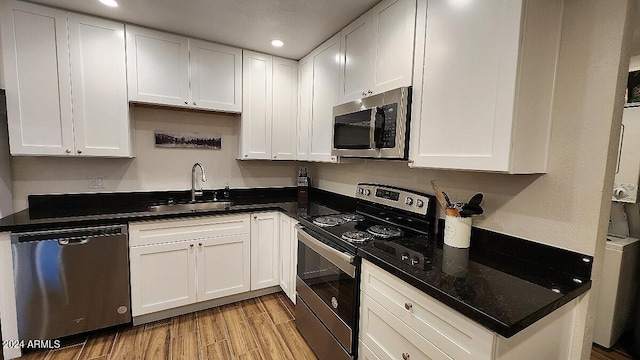 kitchen featuring white cabinets, appliances with stainless steel finishes, and sink