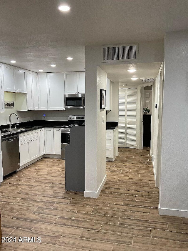 kitchen featuring white cabinets, sink, and stainless steel appliances