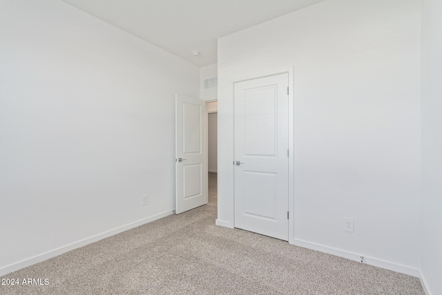 empty room featuring light carpet