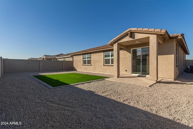 rear view of house featuring a patio area and central AC unit