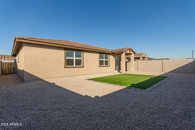 back of house with a patio