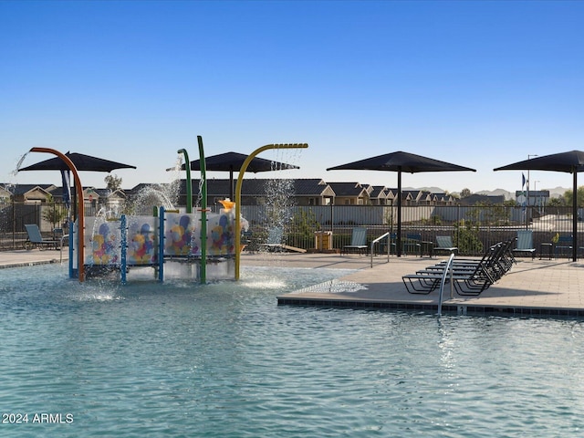 view of swimming pool with pool water feature