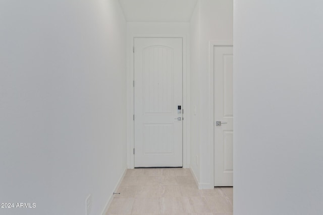 hallway featuring light tile patterned floors