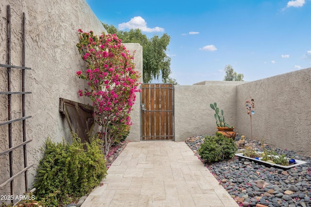 view of gate with fence