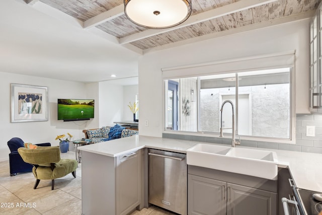 kitchen featuring wooden ceiling, a sink, open floor plan, stainless steel dishwasher, and gray cabinets