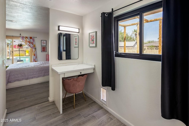 1540 E Glencove St, Mesa, AZ 85203 - bedroom featuring baseboards, wood finished floors, access to outside, and a textured ceiling