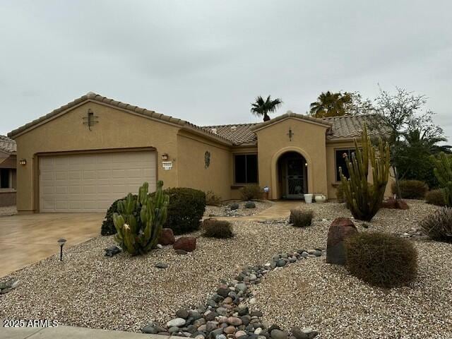 mediterranean / spanish house featuring a garage