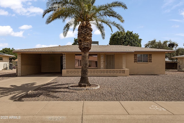 6217 E Dodge St, Mesa, AZ 85205 - ranch-style home with driveway, brick siding, and a carport