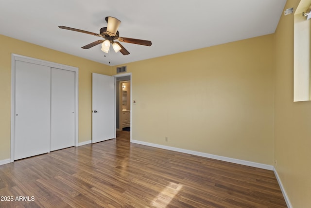 6217 E Dodge St, Mesa, AZ 85205 - unfurnished bedroom with wood finished floors, baseboards, and a ceiling fan
