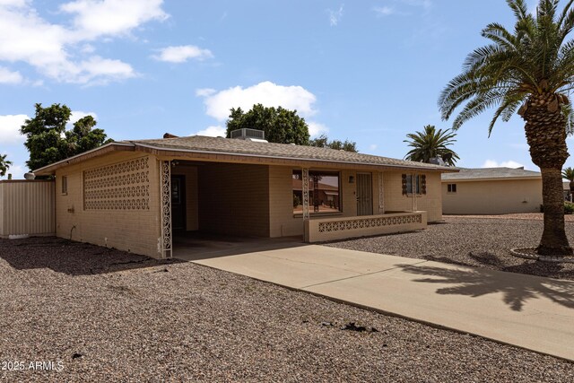 6217 E Dodge St, Mesa, AZ 85205 - ranch-style home with driveway, brick siding, covered porch, and cooling unit
