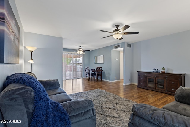 6217 E Dodge St, Mesa, AZ 85205 - living area with a ceiling fan, wood finished floors, and baseboards