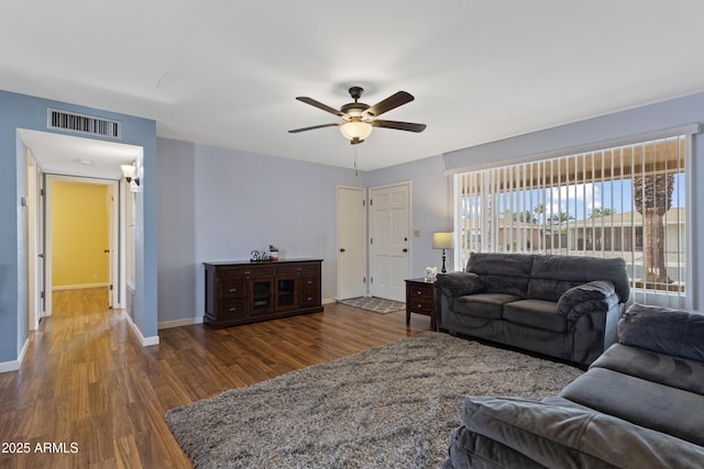 6217 E Dodge St, Mesa, AZ 85205 - living room with dark wood finished floors, ceiling fan, and baseboards