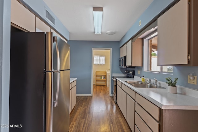 6217 E Dodge St, Mesa, AZ 85205 - kitchen with stainless steel appliances, light countertops, a sink, dark wood finished floors, and baseboards
