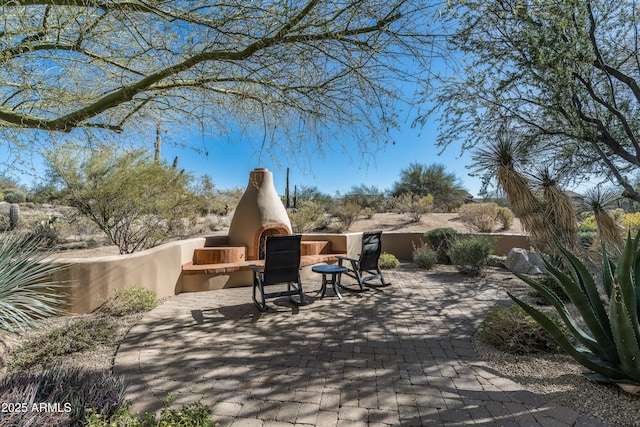 view of patio with an outdoor fireplace