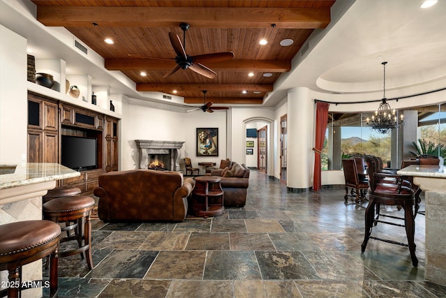 living room featuring ceiling fan with notable chandelier, wooden ceiling, and beamed ceiling