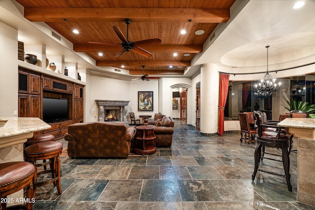 living room featuring beam ceiling, ceiling fan with notable chandelier, and wood ceiling