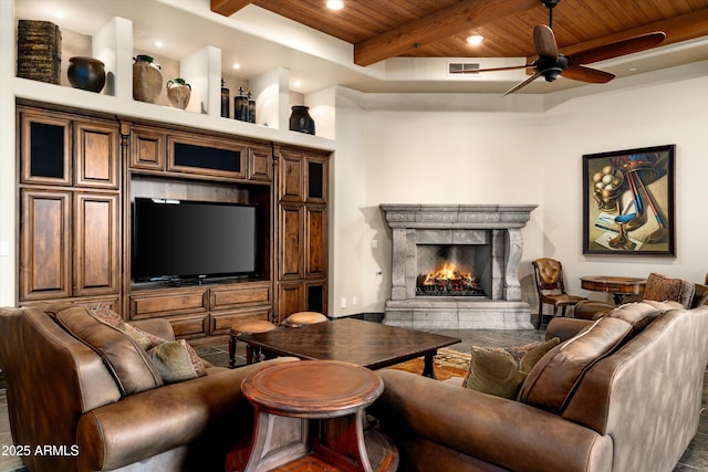 living room with beamed ceiling, ceiling fan, a high end fireplace, and wood ceiling