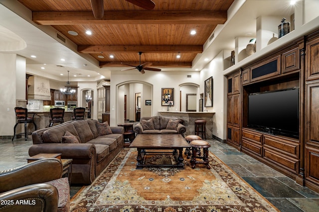 living room with beamed ceiling, ceiling fan, and wooden ceiling