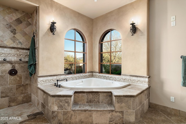 bathroom featuring tiled tub