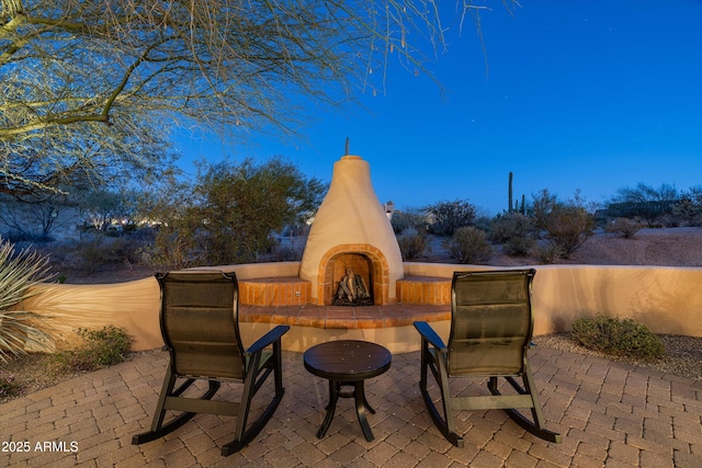 view of patio / terrace with exterior fireplace