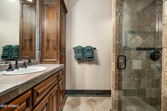 bathroom featuring vanity and a shower with shower door