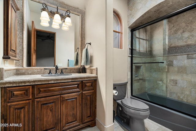 full bathroom featuring tile patterned flooring, enclosed tub / shower combo, vanity, toilet, and an inviting chandelier