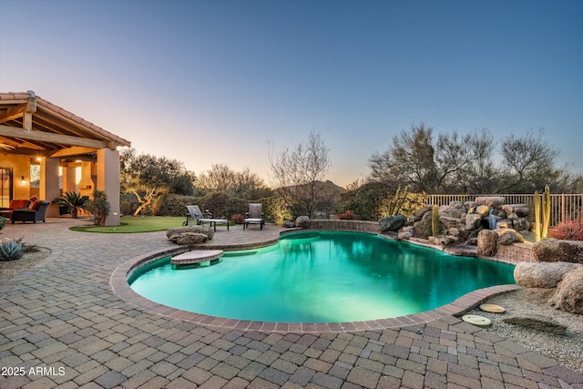 pool at dusk with a patio