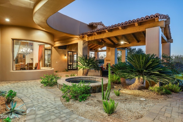 patio terrace at dusk with an in ground hot tub