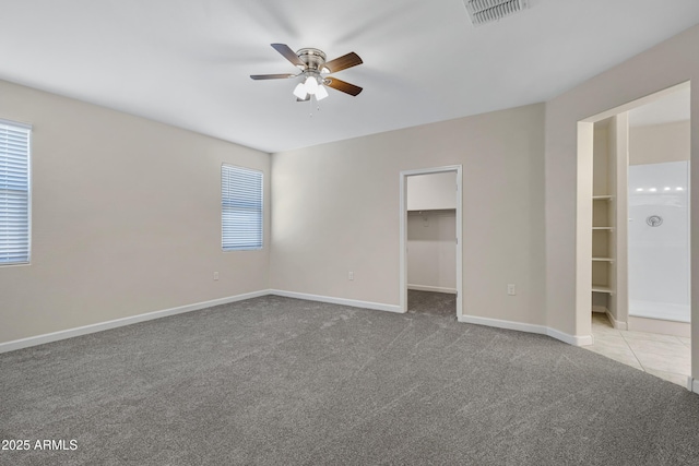 29402 W Mitchell Ave, Buckeye, AZ 85396 - unfurnished bedroom featuring carpet floors, a walk in closet, baseboards, ceiling fan, and a closet