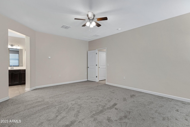 29402 W Mitchell Ave, Buckeye, AZ 85396 - empty room with light carpet, a ceiling fan, and baseboards