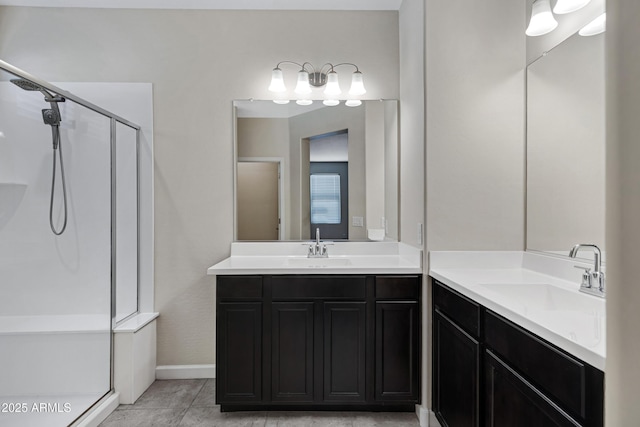 29402 W Mitchell Ave, Buckeye, AZ 85396 - full bathroom with a shower stall, two vanities, and baseboards