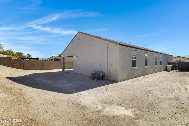 29402 W Mitchell Ave, Buckeye, AZ 85396 - back of house with central air condition unit, a fenced backyard, and stucco siding