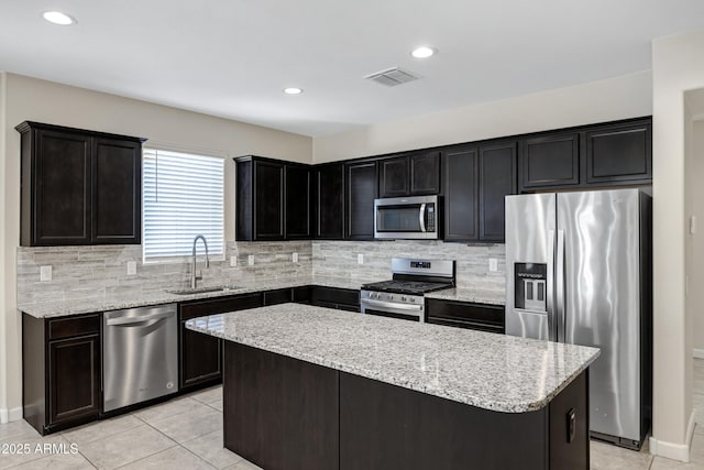 29402 W Mitchell Ave, Buckeye, AZ 85396 - kitchen featuring stainless steel appliances, a sink, a kitchen island, tasteful backsplash, and recessed lighting