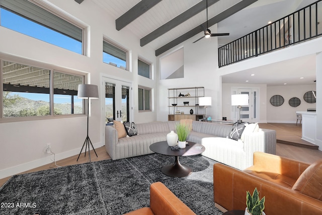 living room with ceiling fan, beamed ceiling, high vaulted ceiling, and french doors