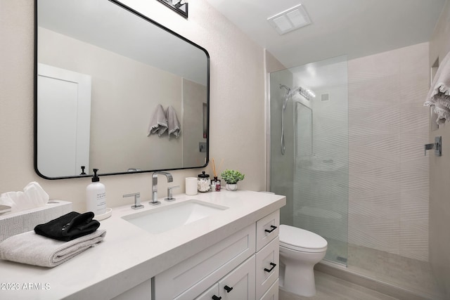 bathroom featuring an enclosed shower, oversized vanity, and toilet