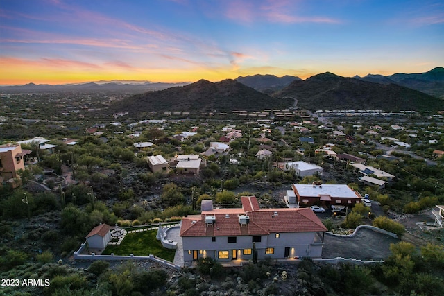 aerial view at dusk featuring a mountain view