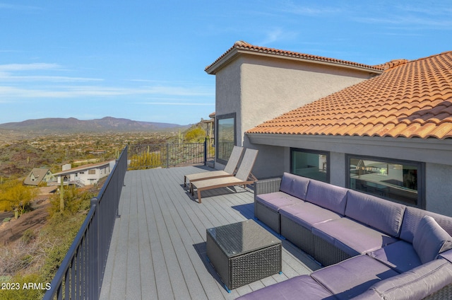 wooden terrace with a mountain view and an outdoor hangout area