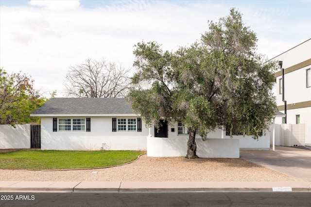 view of front facade featuring stucco siding and fence