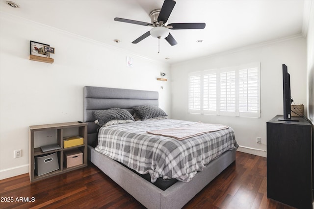 bedroom featuring baseboards, ornamental molding, dark wood finished floors, and ceiling fan