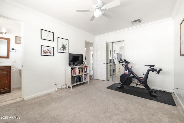 exercise room with light colored carpet, visible vents, baseboards, and ornamental molding