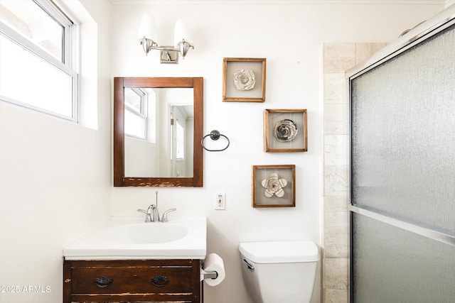 full bathroom with toilet, an enclosed shower, and vanity