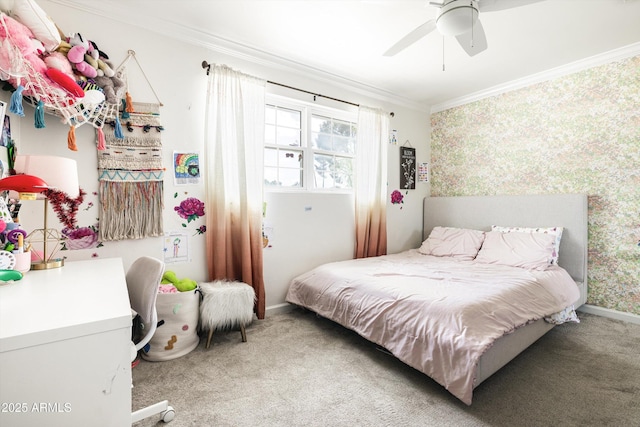 bedroom with a ceiling fan, wallpapered walls, baseboards, crown molding, and carpet floors