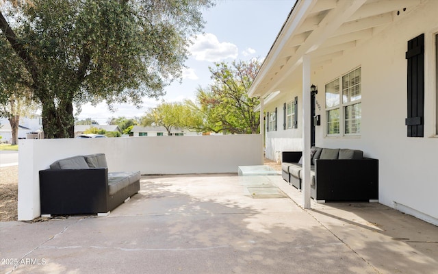 view of patio featuring an outdoor hangout area and fence