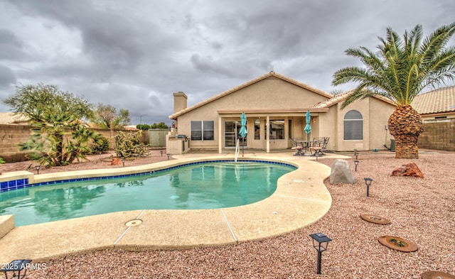 view of swimming pool featuring a fenced in pool, a patio area, and a fenced backyard