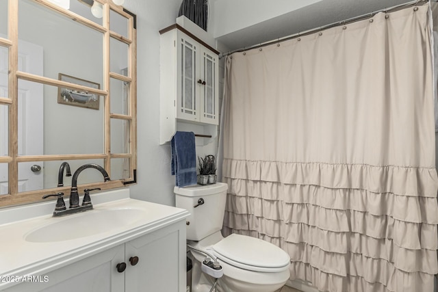 bathroom featuring toilet and vanity