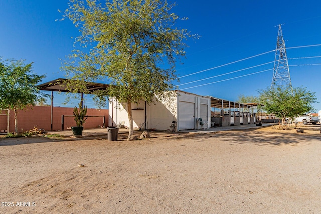 view of yard featuring a garage, an outdoor structure, and fence