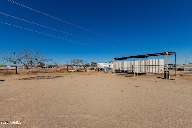 view of yard with a carport and fence