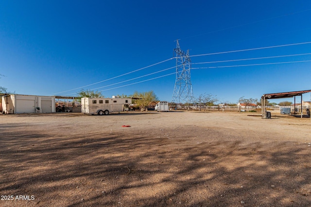 view of yard with an outbuilding and fence