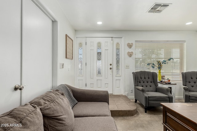 living room with light carpet, recessed lighting, visible vents, and baseboards