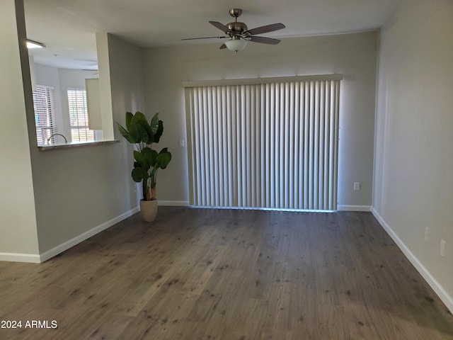 empty room with dark hardwood / wood-style flooring and ceiling fan